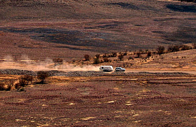 Grey nomad caravan in dust