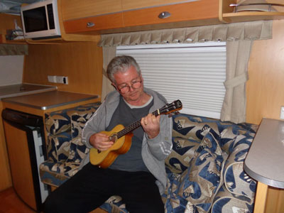 Ukulele playing grey nomad